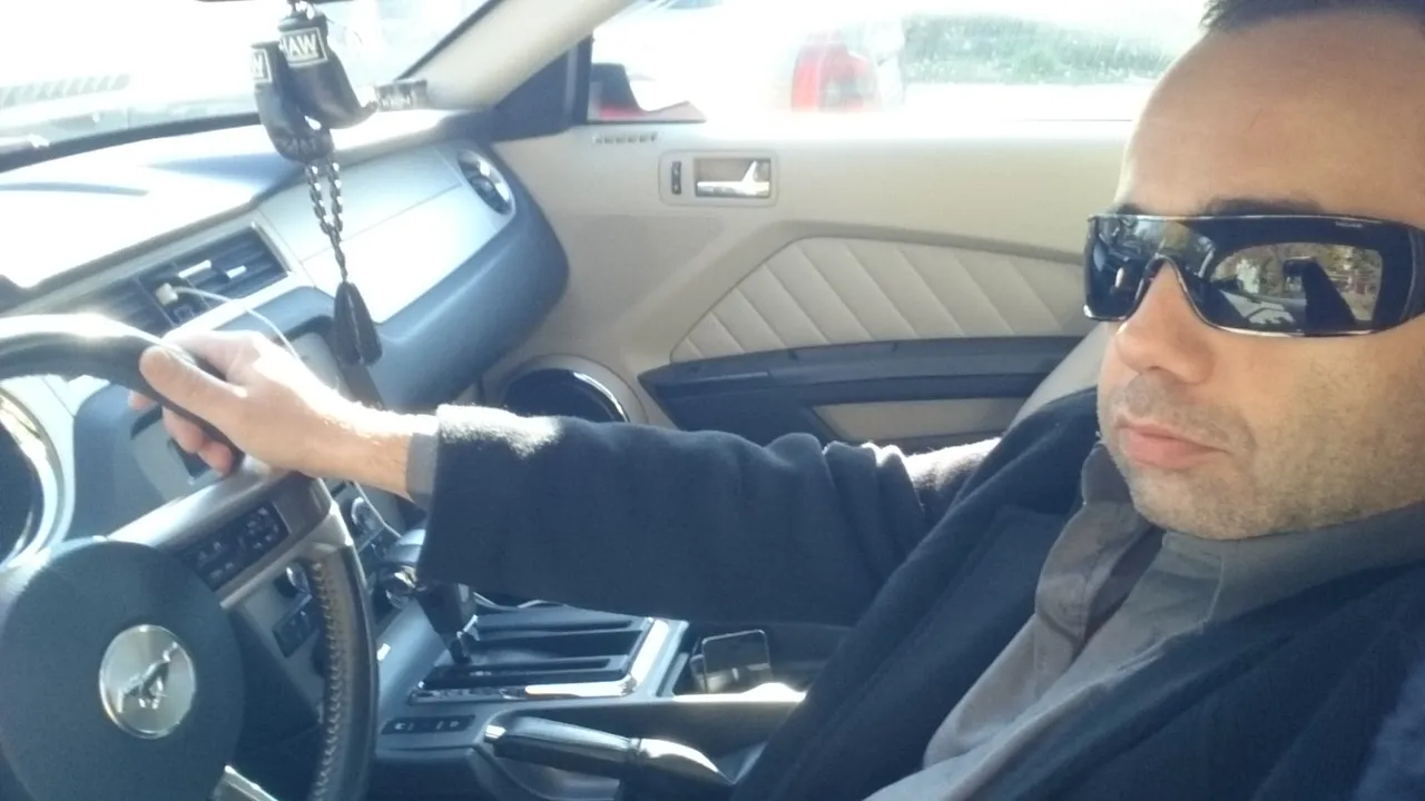 Ivan Pasev behind the wheel of a vehicle.