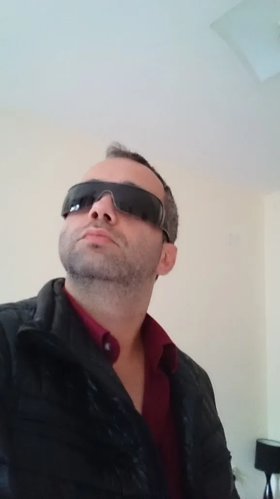 Ivan Pasev wearing glasses, portrait oriented.