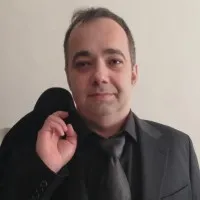 Professional portrait of Ivan Pasev in formal black attire.